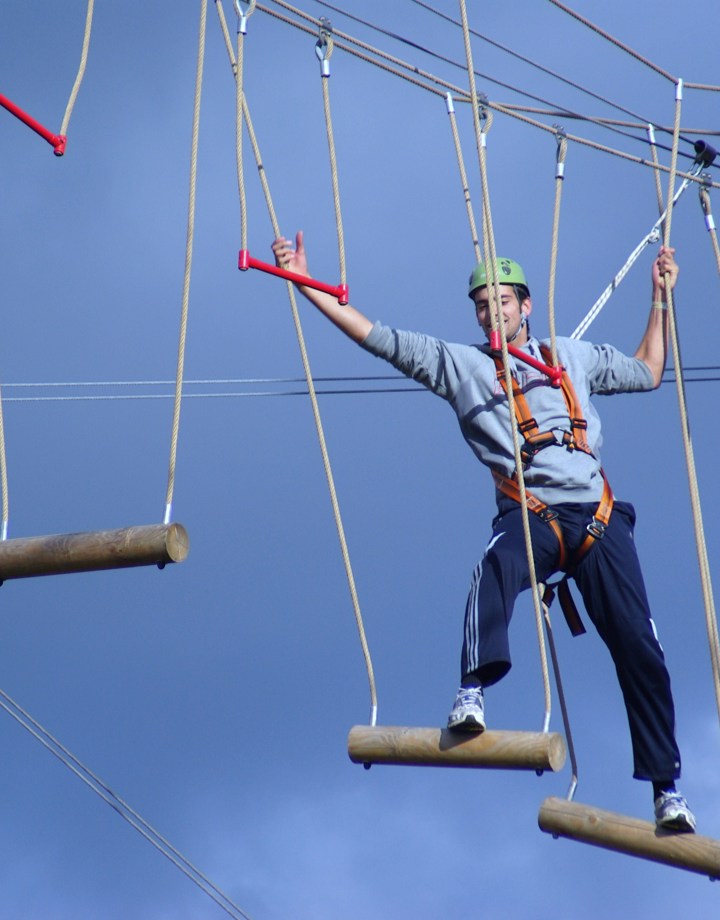 Een man klimt in klimpark bij Snowworld